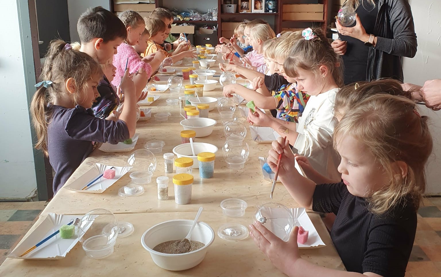  Dzieci przy stołach maluj...